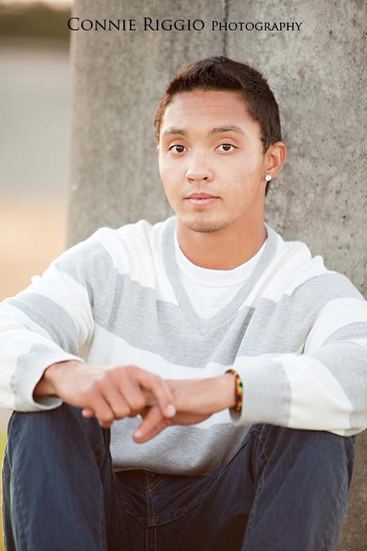 Sitting by pillar looking straight forward Steilacoom Tacoma Seattle Senior Photographer