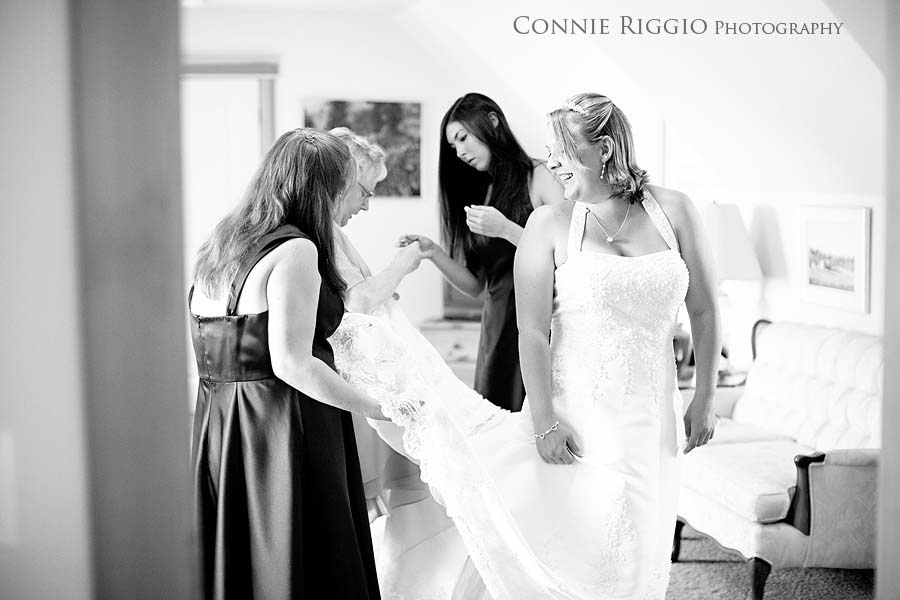 Putting on Dress with everyone Tacoma Wedding Photographer