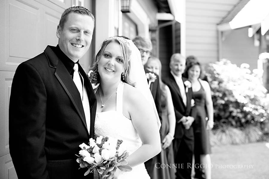 Couple bw with wedding party behind Tacoma Wedding Photographer