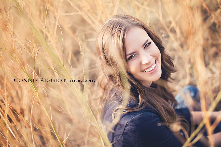 Sitting in field Tacoma Senior Portraits